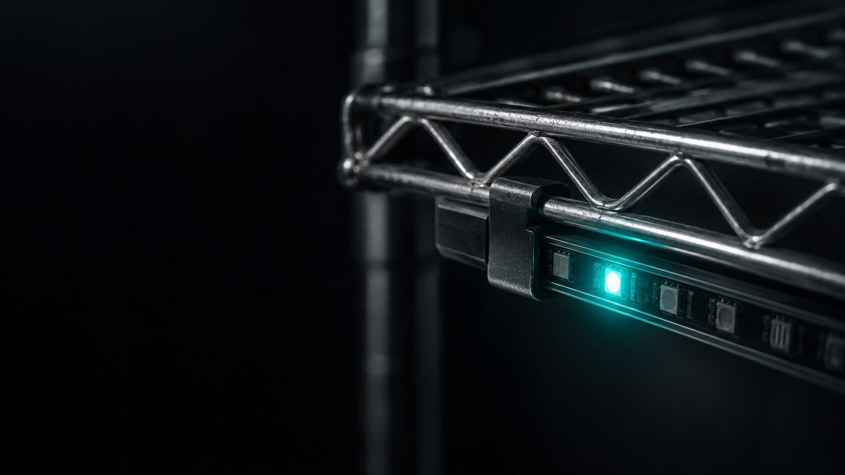 An LED strip device clipped onto the underside of a conventional wire shelf
